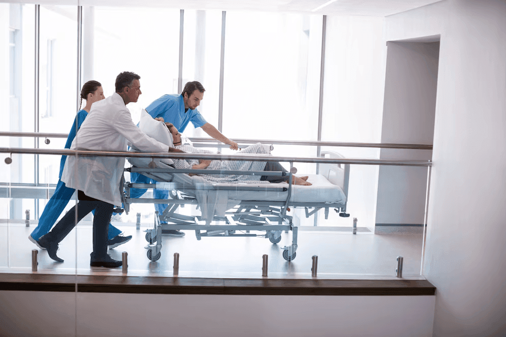 Patient being transported on a stretcher to the Emergency Department at Prakash Hospital.