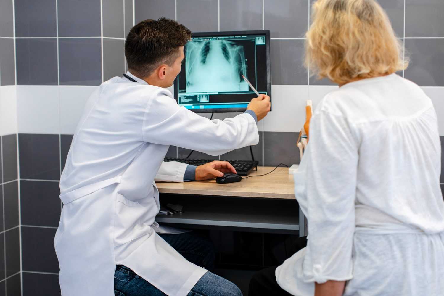 Doctor showing x-ray results to a patient at the Gastroenterology Department of Prakash Hospital.