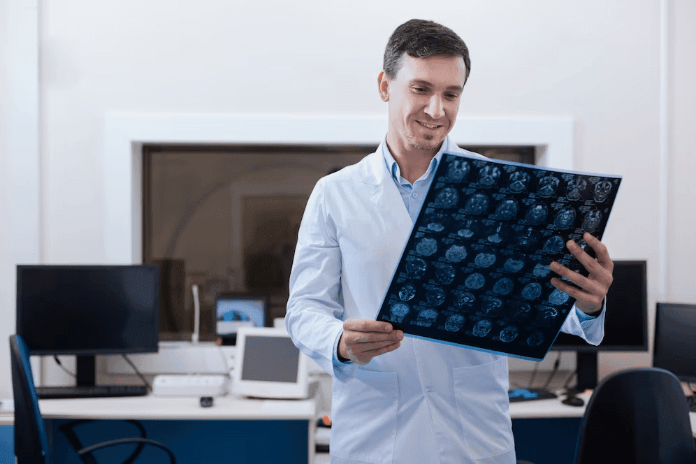 Doctor examining MRI brain scan chart of a patient at Prakash Hospital.