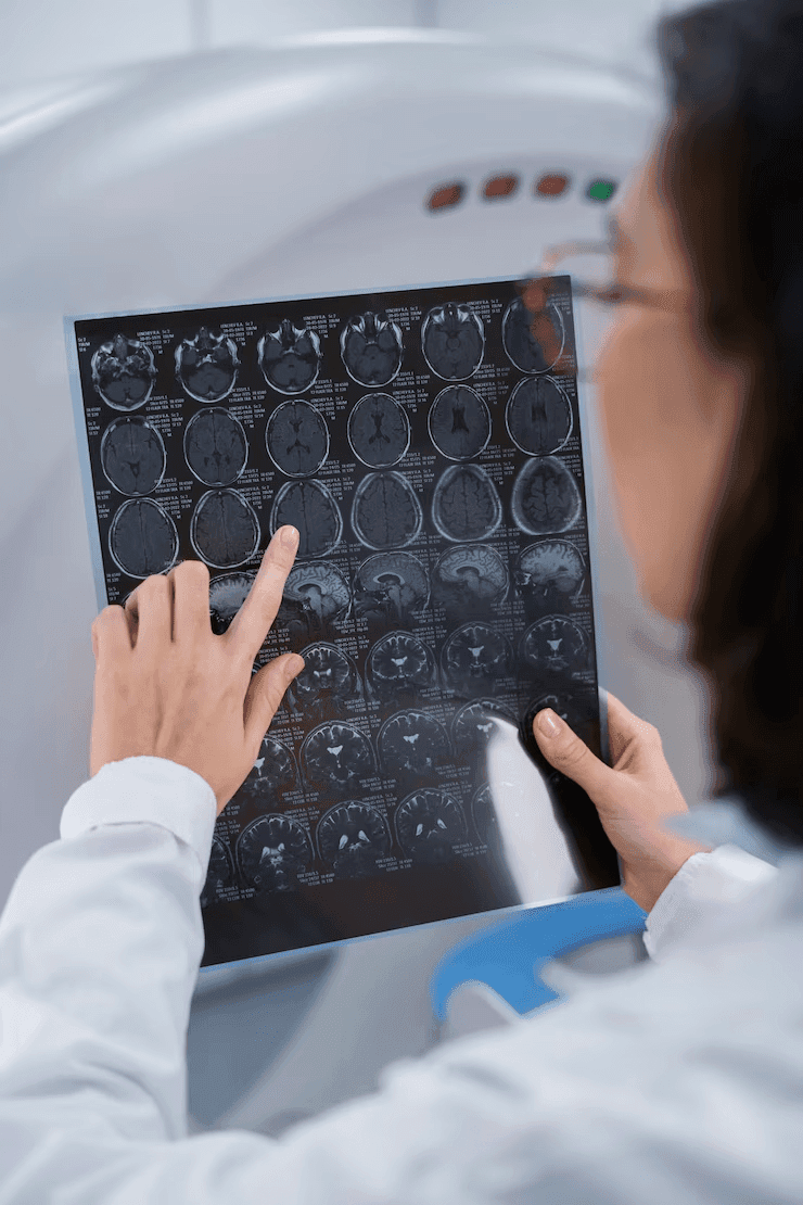 Doctor closely examining brain tissue issues from MRI scan at Prakash Hospital.