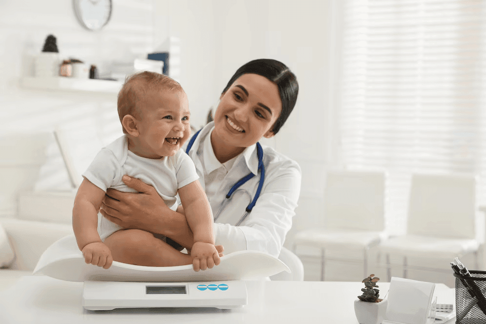 Doctor measuring a newborn’s weight at the Emergency Department of Prakash Hospital.