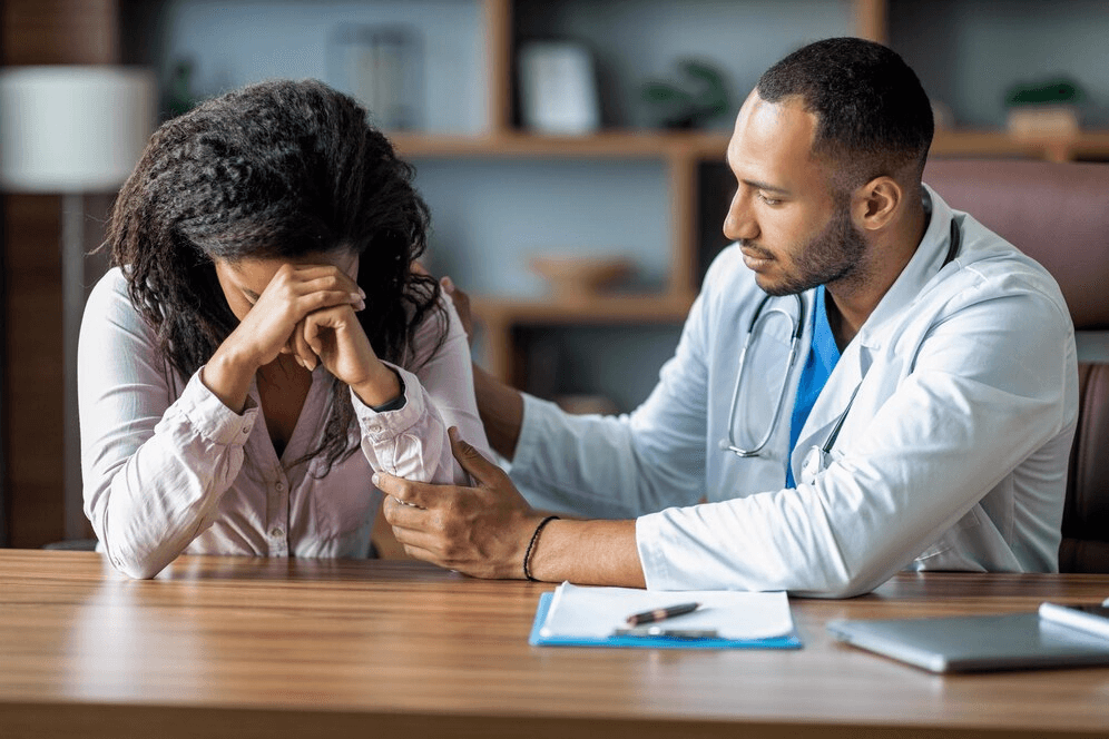 Doctor comforting and reassuring a patient at the Psychiatry Department of Prakash Hospital.